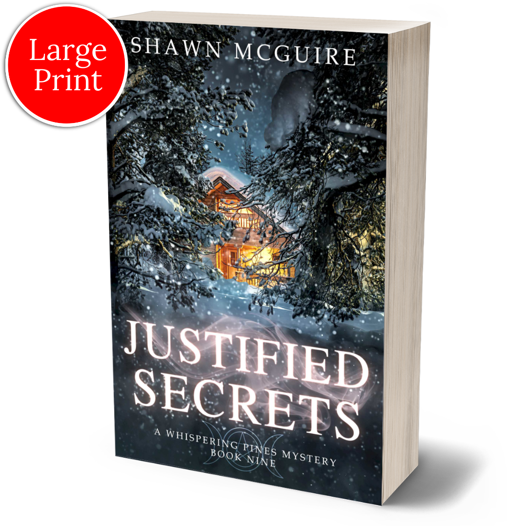 Large print paperback cover of Shawn McGuire's cozy murder mystery featuring a cabin in the woods during a snowstorm.