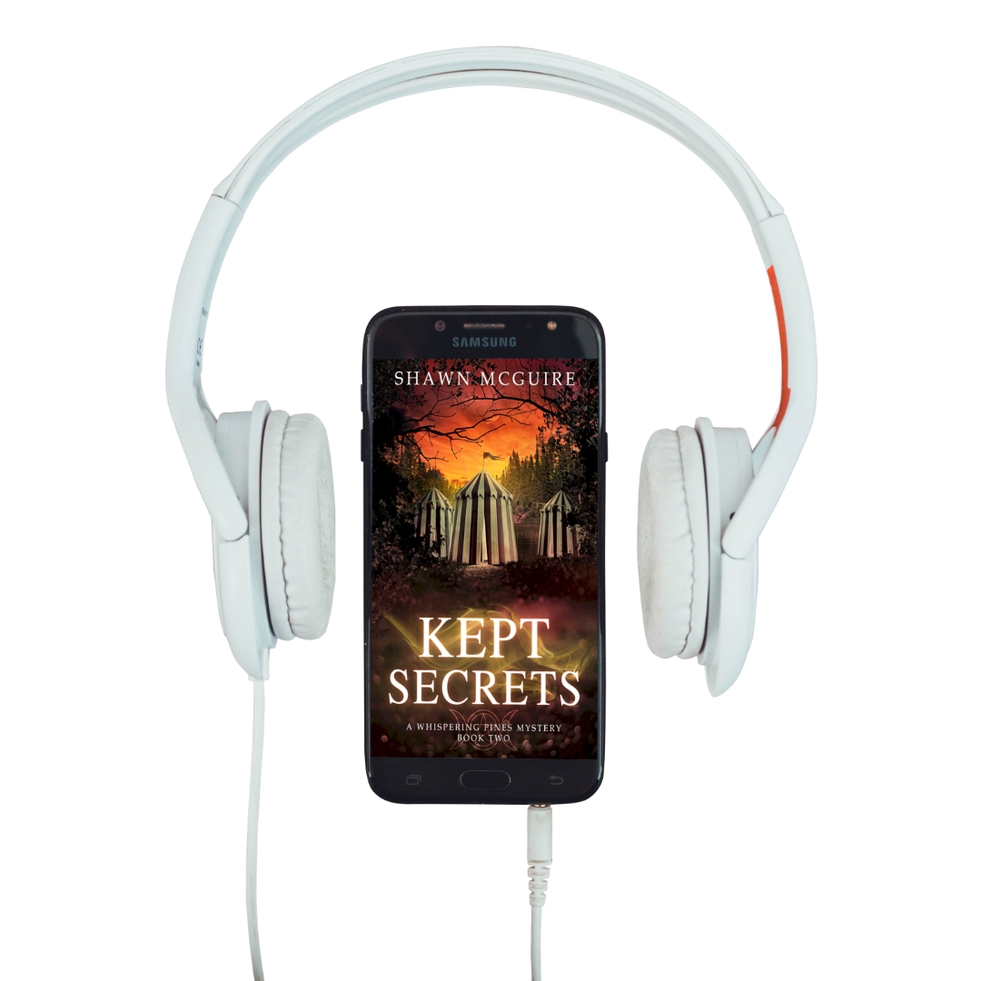 Audiobook cover on cellphone for Shawn McGuire’s cozy murder mystery series set in Whispering Pines, featuring a mysterious woodland circus.