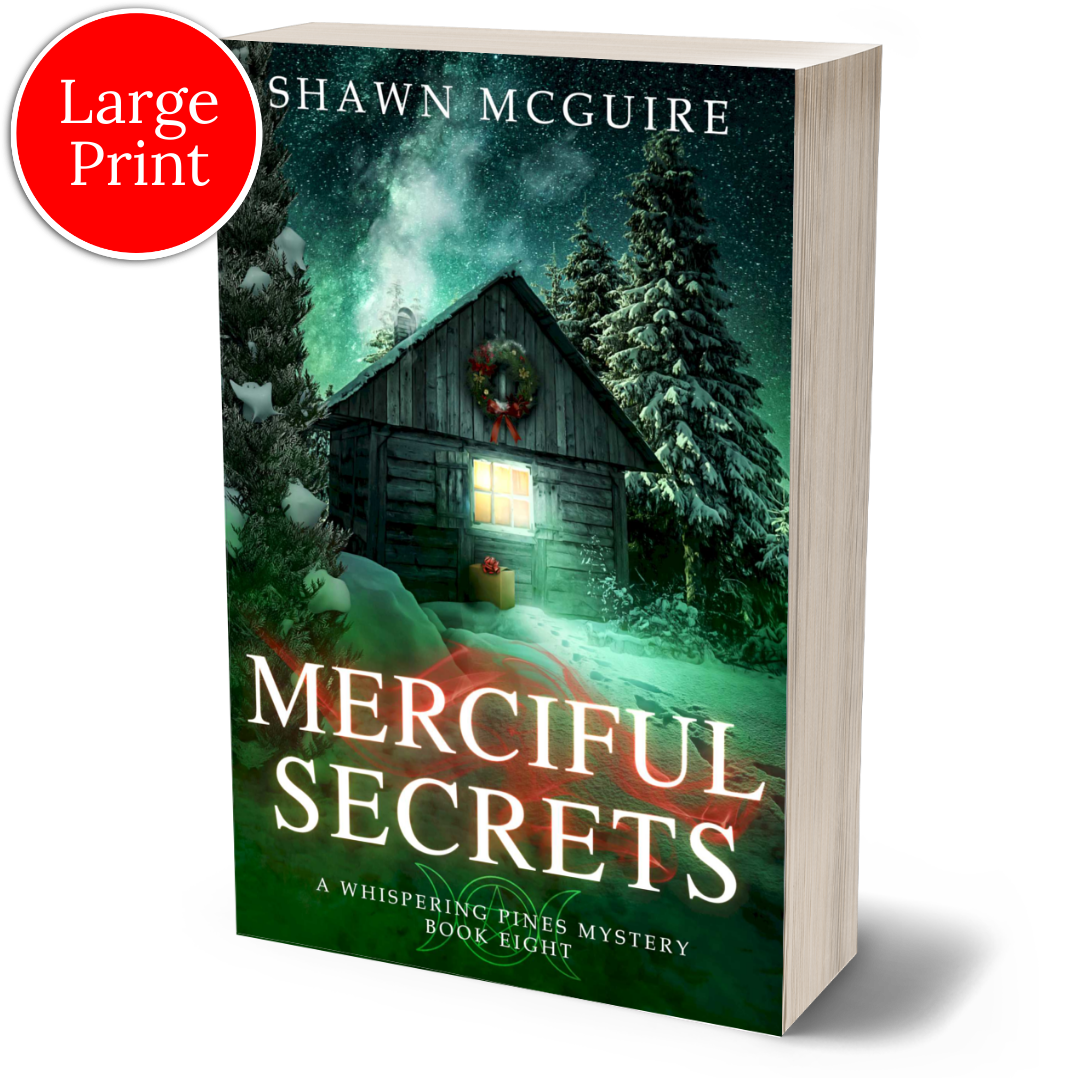 Large print paperback cover of Shawn McGuire's cozy murder mystery featuring a cabin in the woods during Yule.