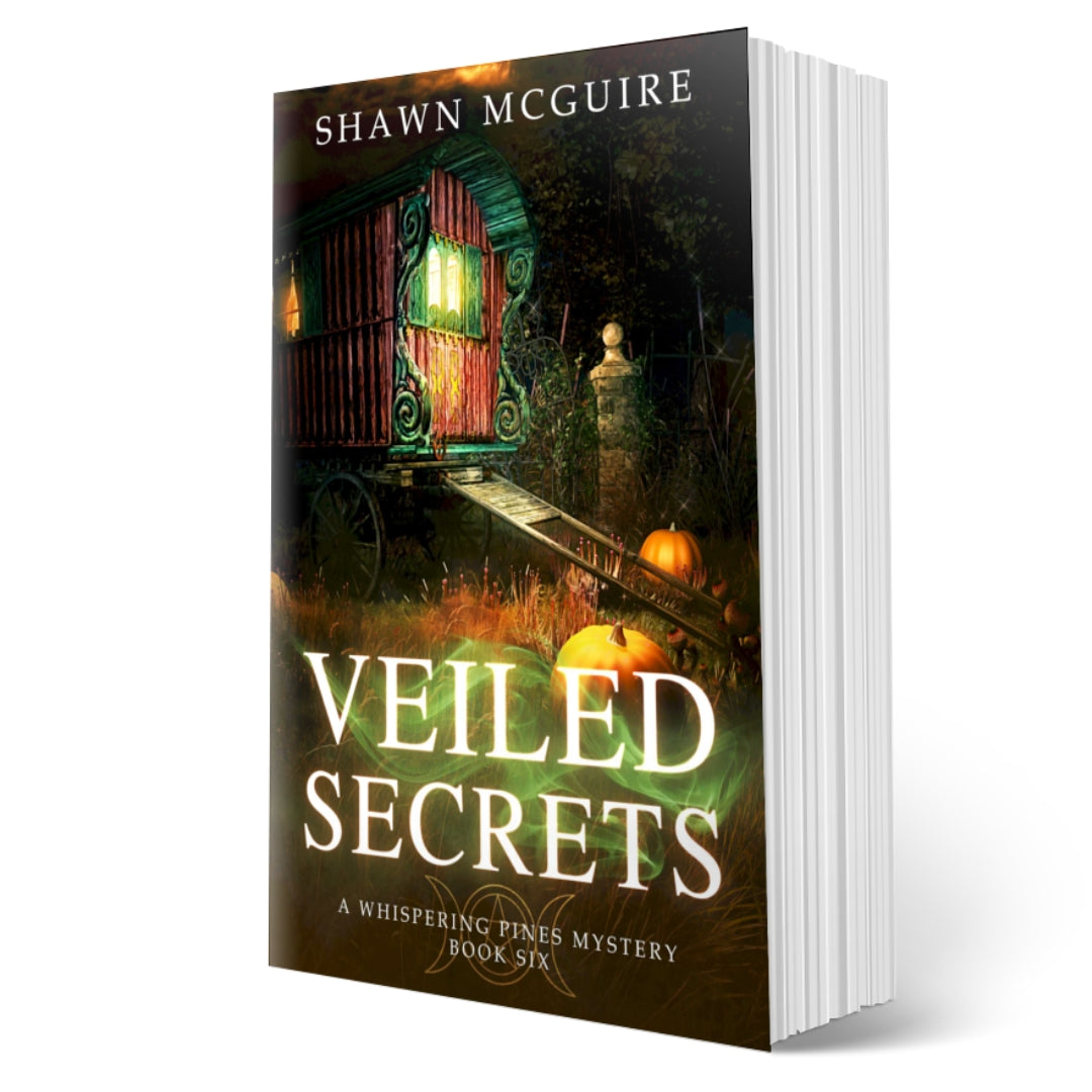 Cover of Shawn McGuire's cozy murder mystery featuring a fortune teller’s wagon and Halloween pumpkins.