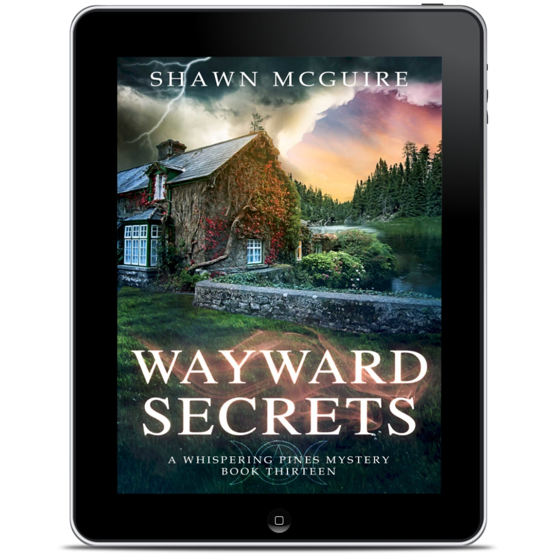 E-book cover on e-reader of Shawn McGuire's cozy murder mystery featuring a stone cottage on a lake beneath an ominous sky.