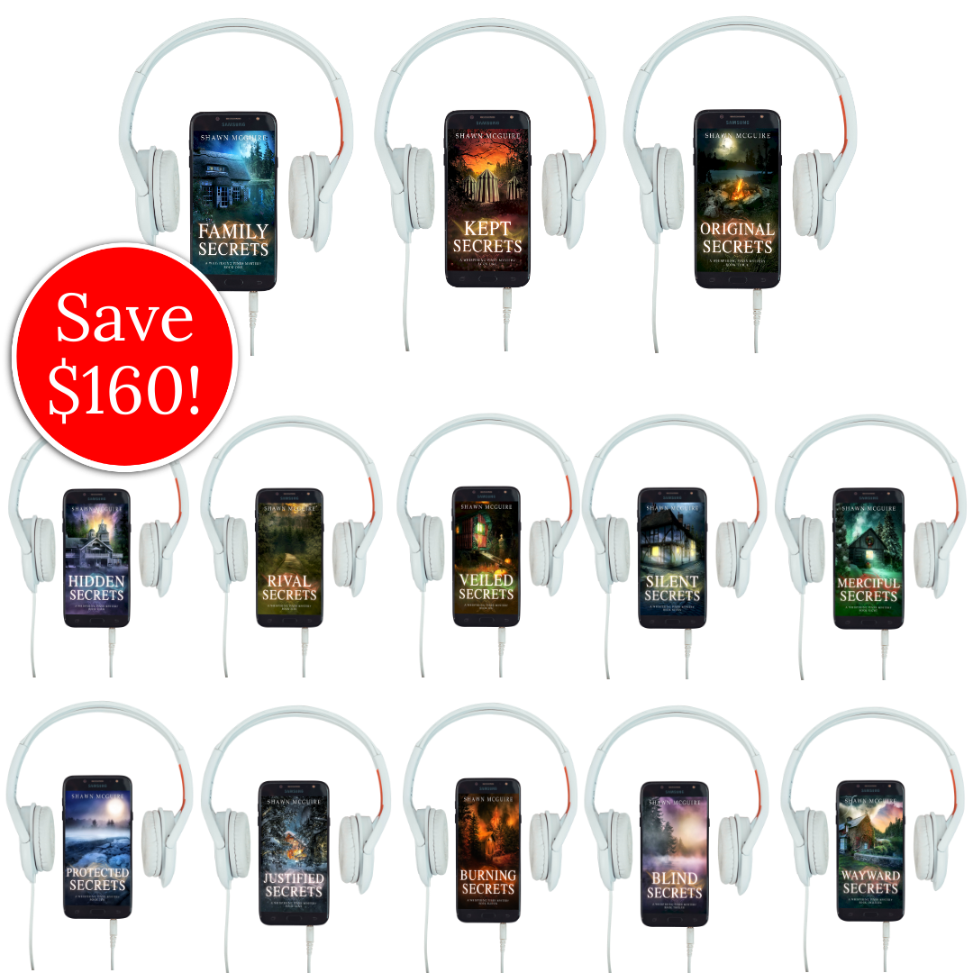 Audiobook covers on cellphones of Shawn McGuire’s 13-book cozy murder mystery series