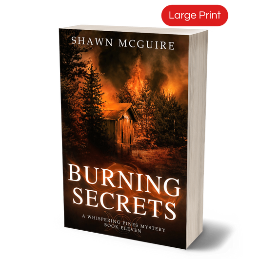 Cover of large print paperback version of Shawn McGuire's cozy murder mystery set in Whispering Pines, featuring a burning forest and shack.