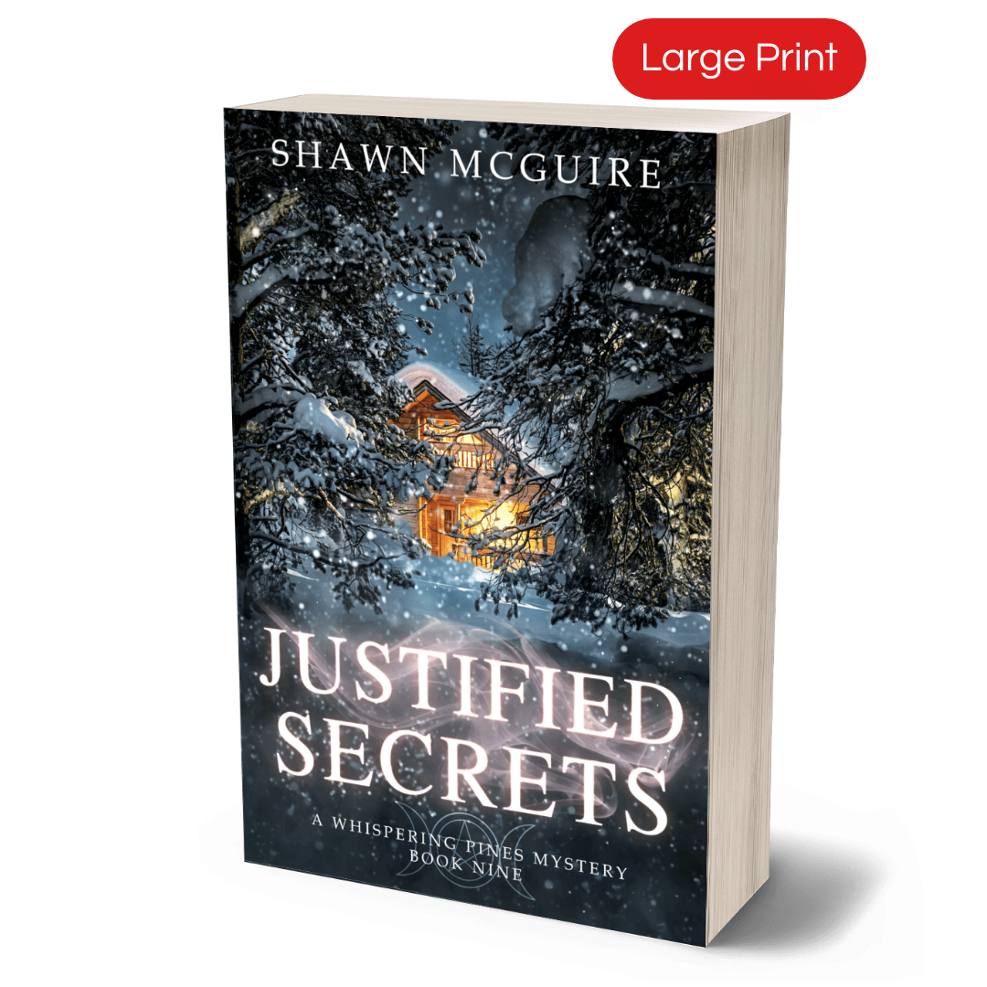 Large print paperback cover of Shawn McGuire's cozy murder mystery featuring a cabin in the woods during a snowstorm.