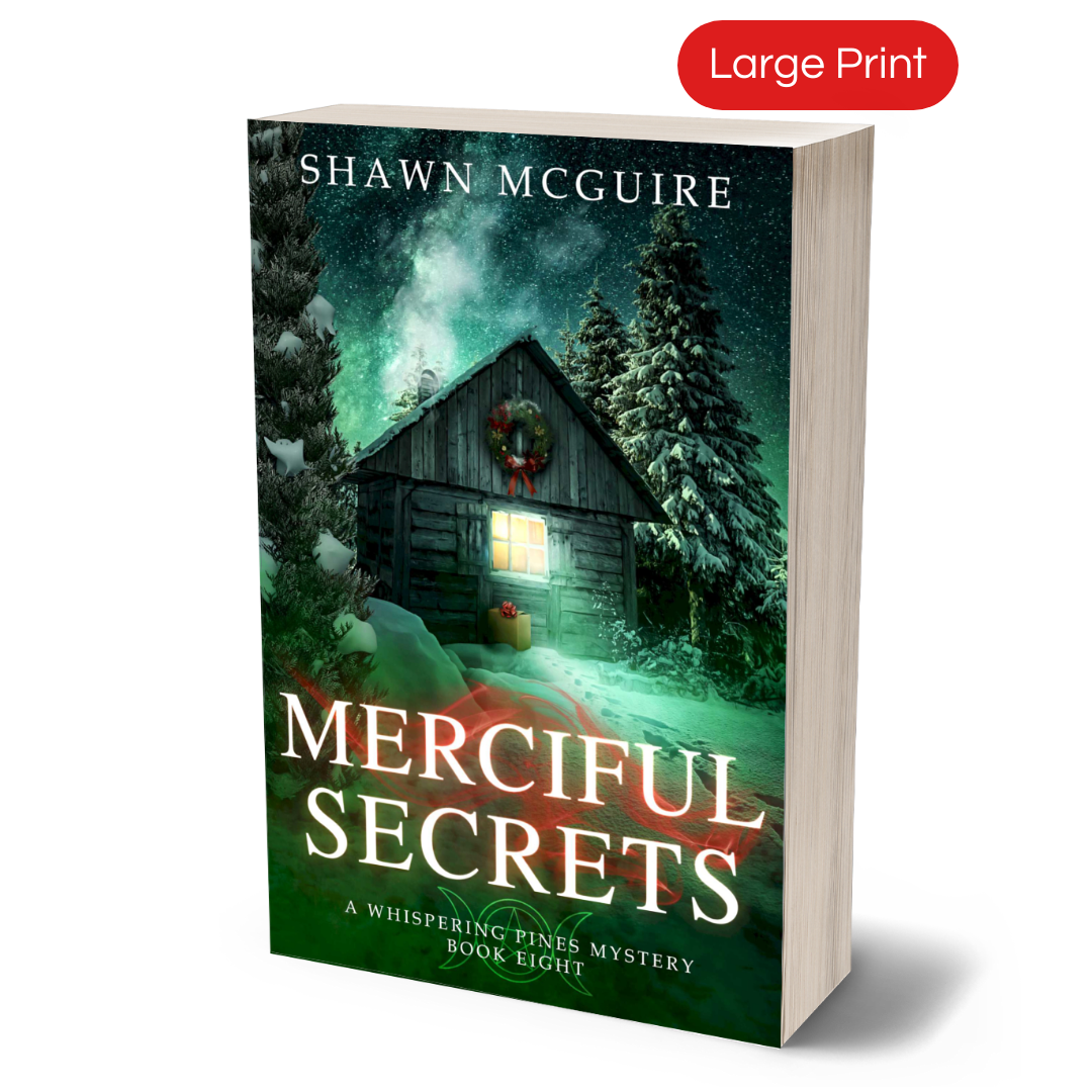 Large print paperback cover of Shawn McGuire's cozy murder mystery featuring a cabin in the woods during Yule.