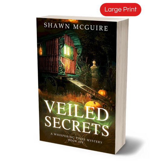 Large print paperback cover of Shawn McGuire's cozy murder mystery featuring a fortune teller’s wagon and Halloween pumpkins.
