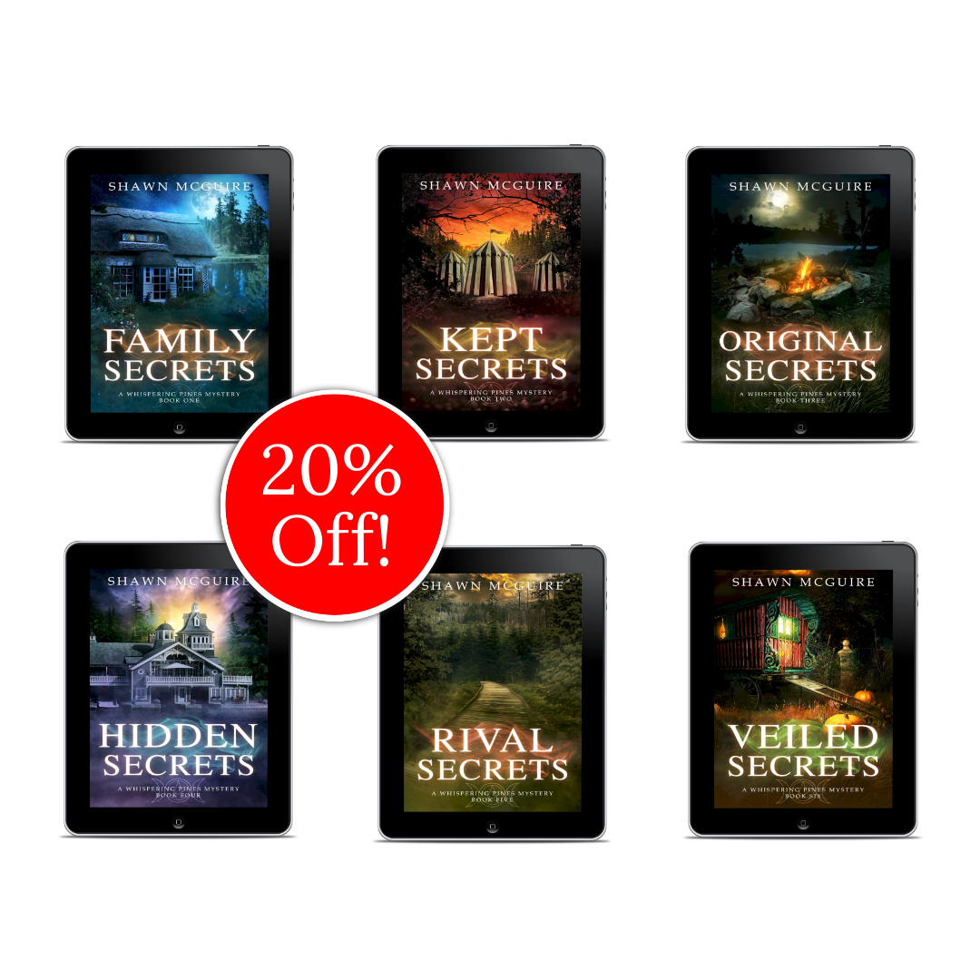 E-book covers on e-readers of Shawn McGuire’s 13-book cozy murder mystery series collection books 1-6.
