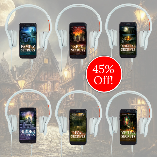 Audiobook covers on cellphones of Shawn McGuire’s 13-book cozy murder mystery series collection books 1-6.