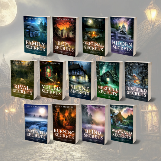 Paperback covers of Shawn McGuire 13-book cozy murder mystery series collection.